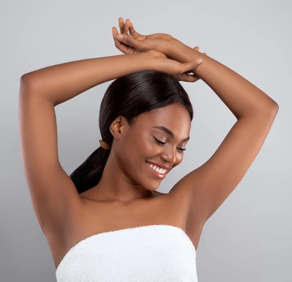 beautiful young woman with toned arms above her head