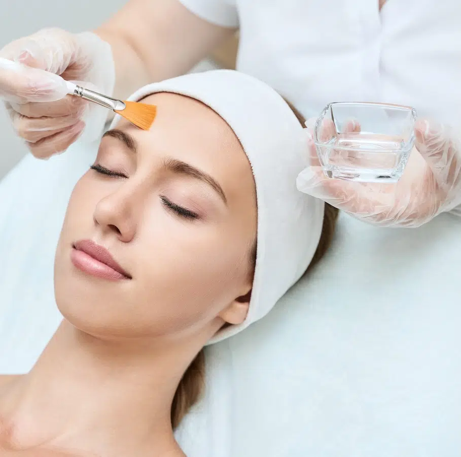 woman receiving chemical peel treatment woman receiving chemical peel treatment