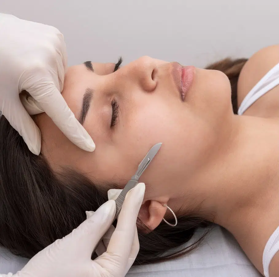 woman receiving dermaplaning treatment woman receiving dermaplaning treatment