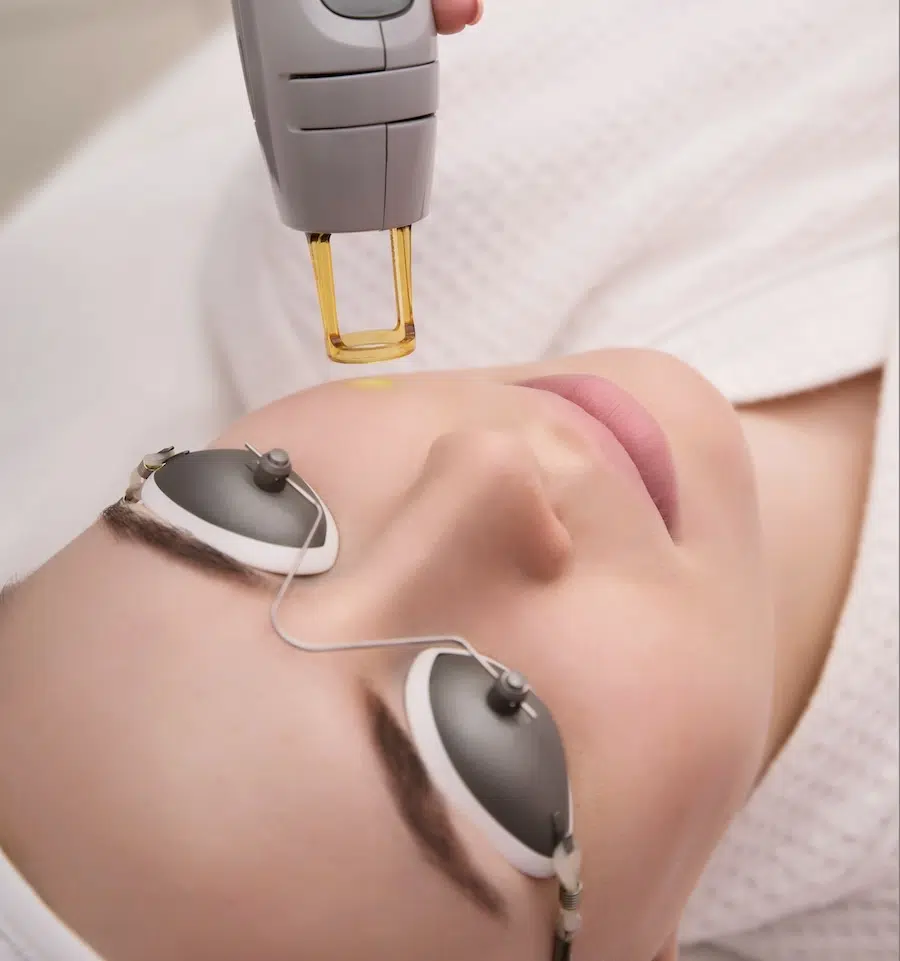 woman receiving laser treatment woman receiving laser treatment